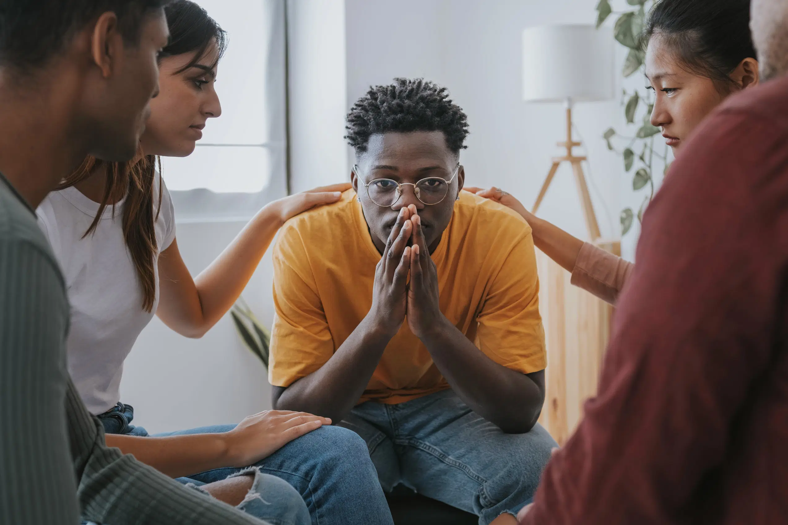 Group comforting a man during a group therapy session for alcohol addiction at My Time Recovery in Fresno.