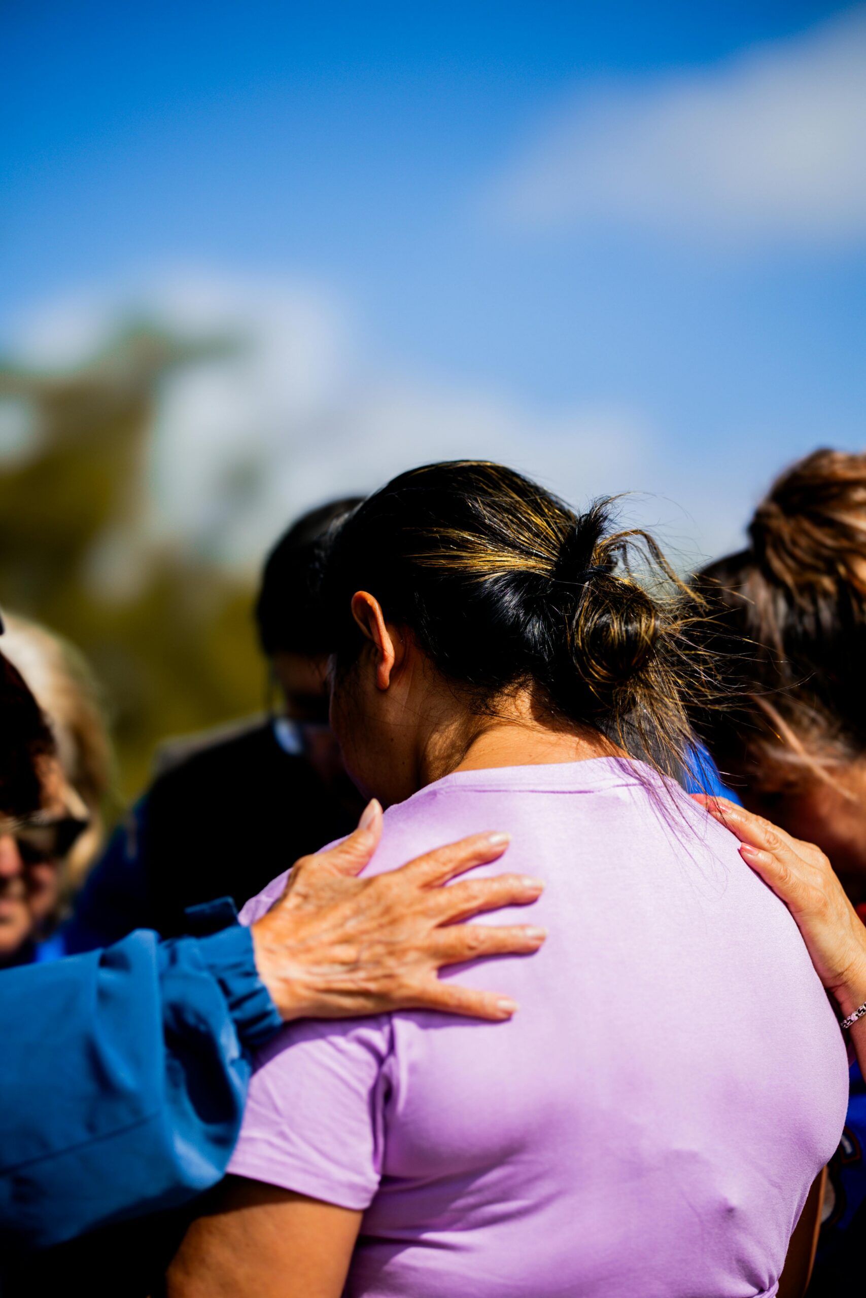 Group of people comforting a woman in distress during a group therapy session at a Fresno Drug Rehab.